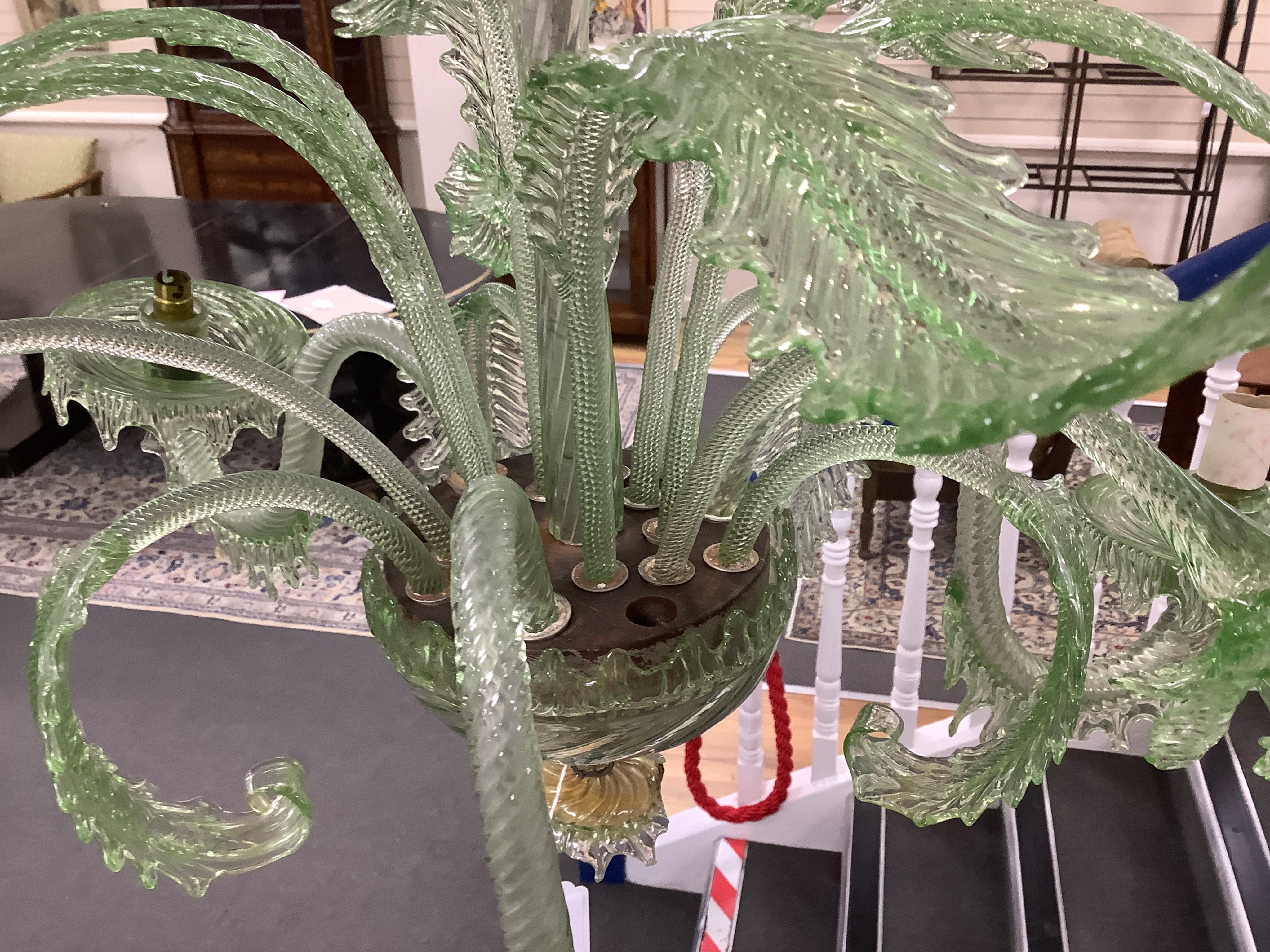 An ornate leaf and floral green glass Murano three branch chandelier, 84cm high.